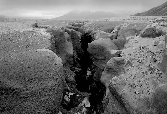 Knife Creek Canyon revealed below a decaying snow bridge, 2002. (© Gary Freeburg)